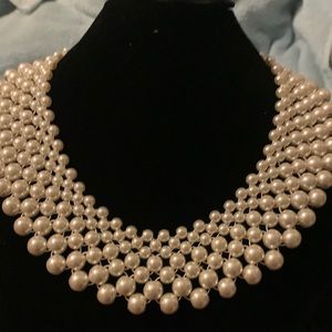 Faux pearl graduated size collar choker necklace with silver tone connector.